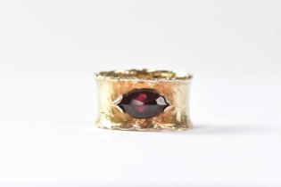 A 9ct yellow gold wide band ring set with a marquise-shaped garnet, size U, approx. 6.6g.