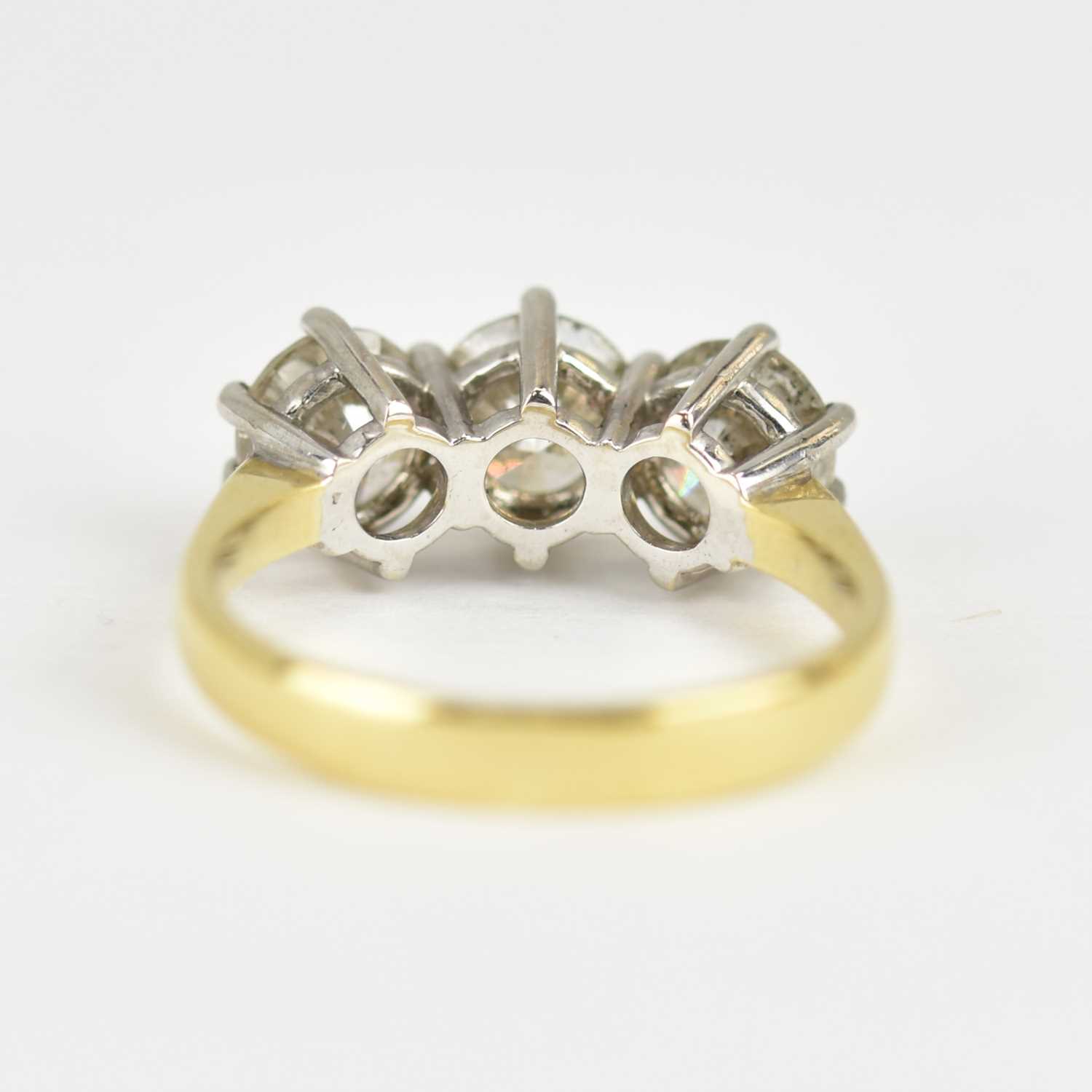 An 18ct yellow ring set with three claw set brilliant cut diamonds, each approx. 0.6ct, total 1.8ct, - Image 3 of 4
