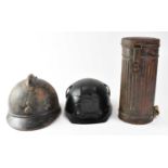 A WWII German M30 gas mask with FE41 filter in original tin, a WWI period French M15 infantry helmet