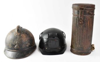 A WWII German M30 gas mask with FE41 filter in original tin, a WWI period French M15 infantry helmet