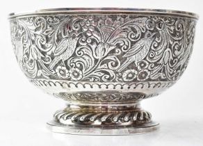 A Victorian silver bowl with embossed decoration of birds within scrolling flowers, engraved