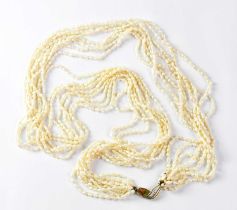 An eight-strand natural seed pearl necklace with a 14K yellow and white gold clasp, length approx.