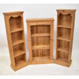 A pine bookcase of three shelves with reeded supports, 107 x 59 x 22.5cm, together with a pair of