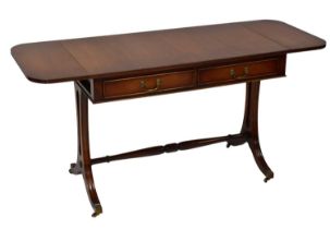A Georgian-style mahogany sofa table with two drawers above reeded outswept legs, united by a