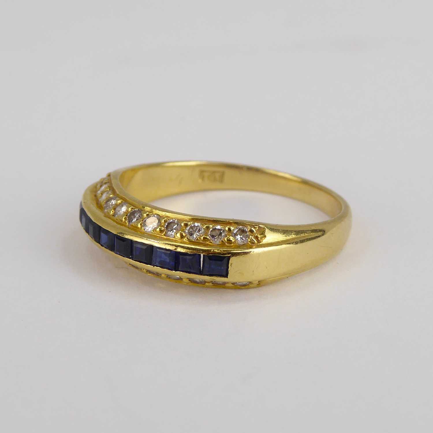 An 18ct gold diamond and sapphire ring, the four central channel set square cut sapphires flanked by - Image 8 of 9