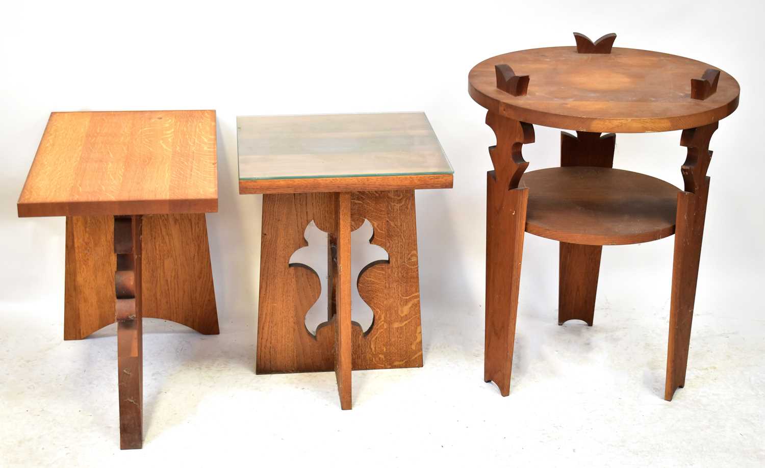An oak rectangular top side table with stylised base, 58 x 64 x 40cm, together with two Arts and