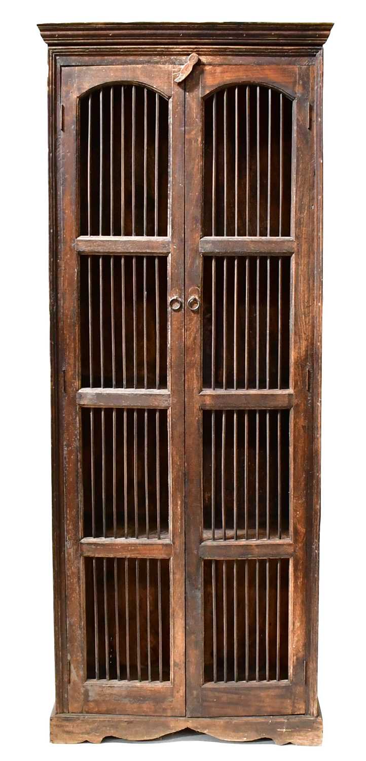 A Colonial-style dark stained two-door food cabinet, each door with arched panel and barred doors,