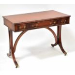 A Georgian-style mahogany side table with three drawers above reeded and outswept legs, with brass