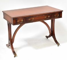 A Georgian-style mahogany side table with three drawers above reeded and outswept legs, with brass