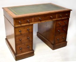 An early 20th century oak pedestal desk with inset green leather top, over three drawers, on banks