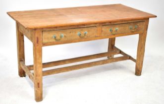 A late 19th century Irish-style large pine school desk/kitchen table with overhanging top over two