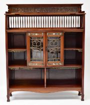 SHAPLAND & PETTER, BARNSTAPLE; an Art & Crafts walnut bookcase, with three-quarter galleried top