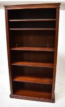 A mahogany freestanding open bookcase, with dentil moulded cornice above five adjustable shelves and