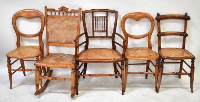 Five various Victorian and Edwardian bergère seated chairs comprising a pair of balloon backs, a