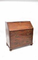 A George III mahogany bureau, the fall front enclosing a fitted interior and baize-lined writing