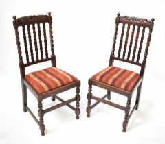 A set of four early 20th century oak dining chairs with carved top rail above slat back, drop-in