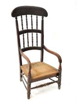 A 19th century high back nursing chair with double row spindles, curved hand-rails and woven