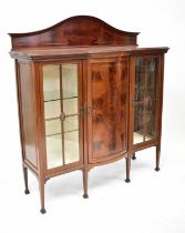 An Edwardian-style mahogany display cabinet with two astragal glazed doors, raised on tapered