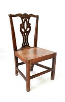 A late Georgian rustic oak dining chair with pierced vase splat, raised on square section