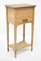 An early 20th century pine sewing box with hinged top, fitted interior, single drawer to tapered