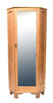 A pine corner wardrobe with bevelled mirror glass door and raised on bracket feet, 201 x 89 x