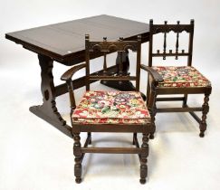 ERCOL; a dark stained dining suite comprising a draw-leaf table, five chairs (4+1) and a dresser