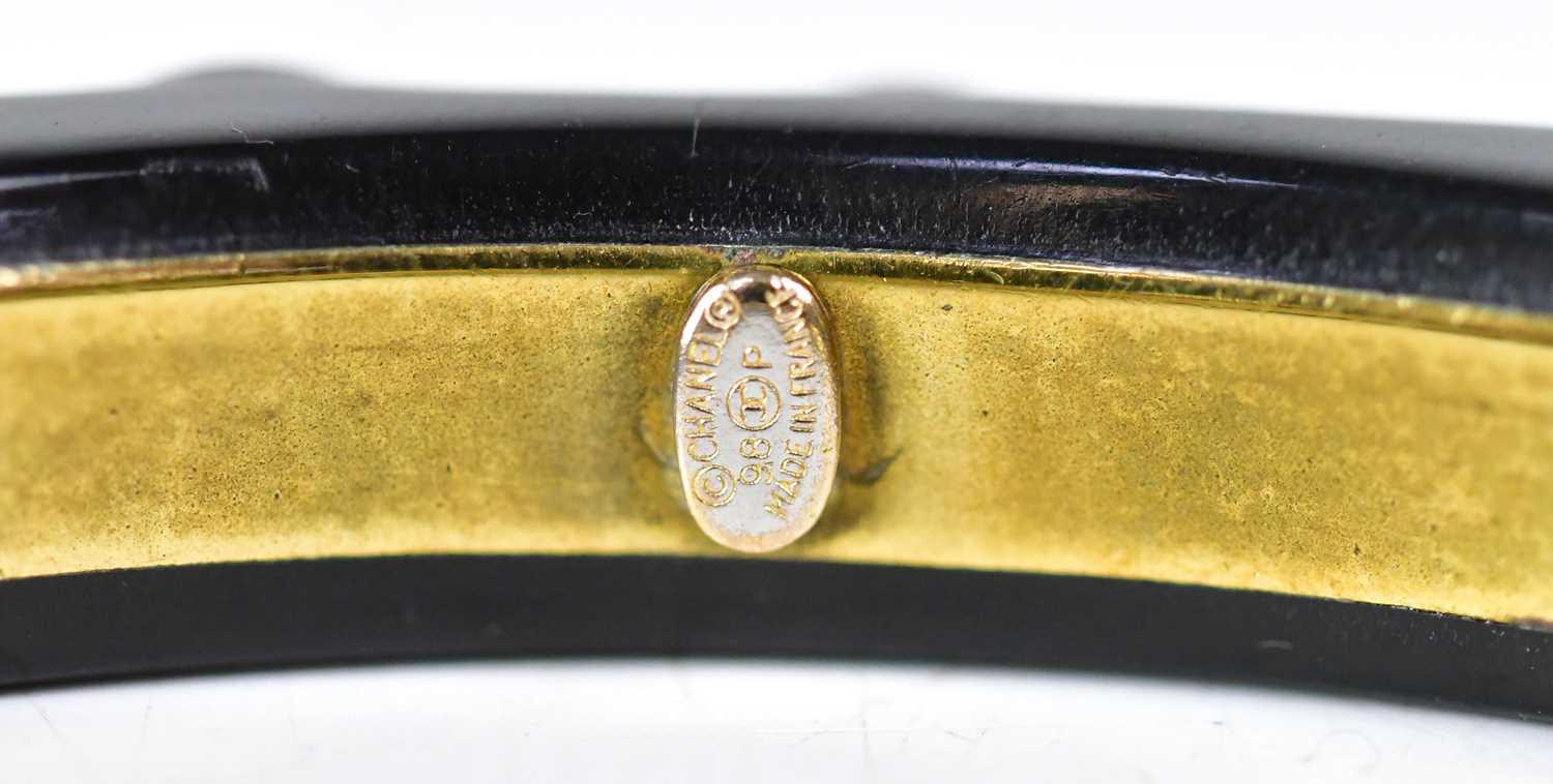 CHANEL; a black resin bangle set with diamanté and double C logo in gold plate, stamped to interior, - Image 2 of 2