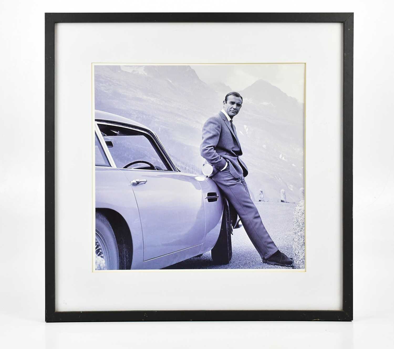 JAMES BOND INTEREST; black and white photograph, Sean Connery with Aston Martin DB5, during the