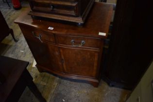 A reproduction burr walnut veneered serpentine fronted side cabinet, with two drawers above two