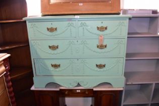 A green painted chest of two short over two long drawers, with relief swags and bows, width 107cm,