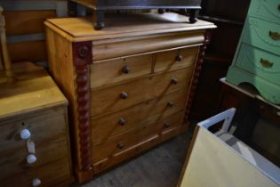 An old pine chest of drawers with frieze drawer above two short and three long drawers, on plinth