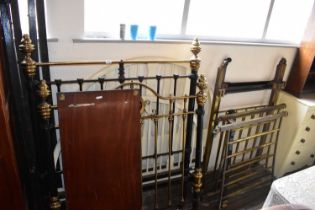 A collection of Victorian and later metal and wooden bed frames.