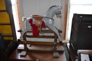 A vintage painted rocking horse, height 84cm. Condition Report: General wear throughout, losses