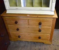 An old pine chest of two short over two long drawers, with turned bun handles, width 107cm, depth