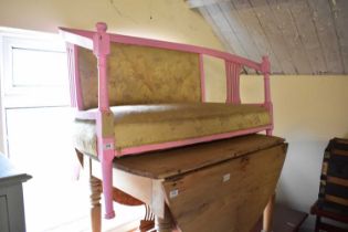 An Edwardian pink painted settee on turned column supports, width 122cm.