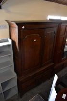 An 18th century press cupboard with moulded cornice above pair of panelled doors and an