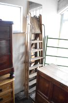 A vintage pair of wooden stepladders, together with a rectangular wall mirror (2).