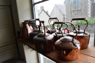 A collection of 19th century copper kettles and three copper haystack jugs (9).