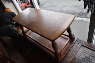 A Victorian cast metal pub table with wooden top and a Priory style oak refectory coffee table (2).