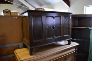 A 1950s oak blanket chest with panelled front, on bun feet, width 88cm, depth 43cm, height 65cm.