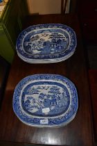 Eleven 19th century blue and white ironstone meat plates in a 'Willow' pattern.