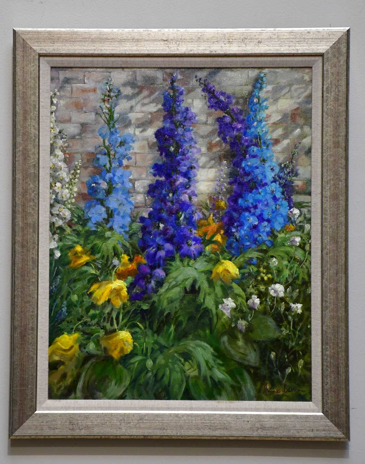 † JUNE BEVAN; oil on canvas, 'Delphiniums in my Garden', signed lower right, 49 x 38cm, framed.