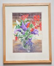 † JUNE BEVAN; watercolour, 'Lilac and Crocosmia', signed lower left, 37 x 26cm, framed and glazed.