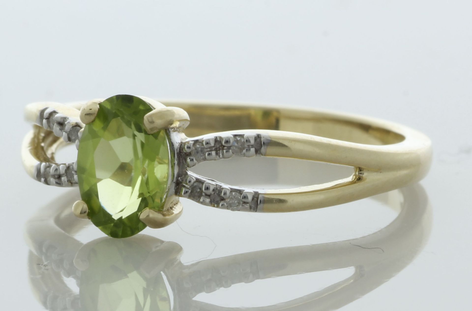 9ct Yellow Gold Diamond And Peridot Ring (P0.69) 0.03 Carats - Valued By IDI £1,585.00 - An oval 7mm - Image 2 of 4