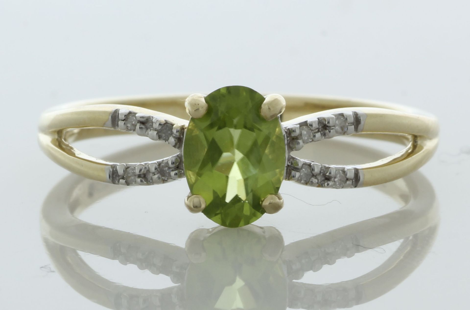 9ct Yellow Gold Diamond And Peridot Ring (P0.69) 0.03 Carats - Valued By IDI £1,585.00 - An oval 7mm