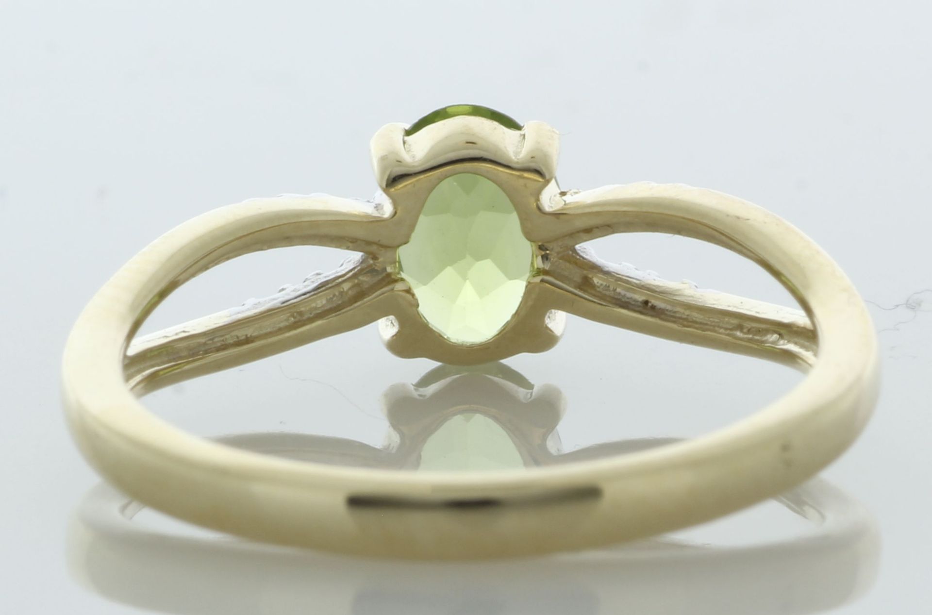 9ct Yellow Gold Diamond And Peridot Ring (P0.69) 0.03 Carats - Valued By IDI £1,585.00 - An oval 7mm - Image 3 of 4