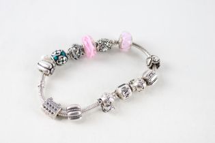 A silver bracelet filled with assorted charms, by Pandora (50g)