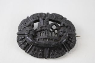 A large Victorian Irish bog oak brooch depicting Mucross Abbey (29g)