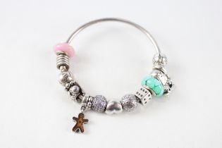 A silver bracelet filled with assorted charms, by Pandora (49g)
