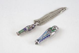 Two silver 1920s Egyptian revival opening mummies, one suspended from a silver chain (13g)